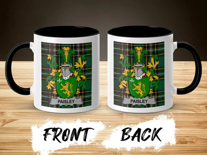Two white mugs with black rims, each displaying a green and gold family crest with "Paisley" text.