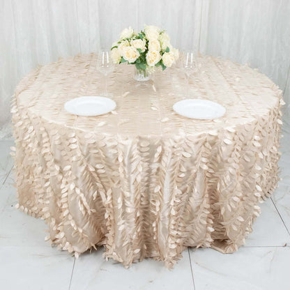 Elegant round table with a textured beige tablecloth and floral centerpiece.